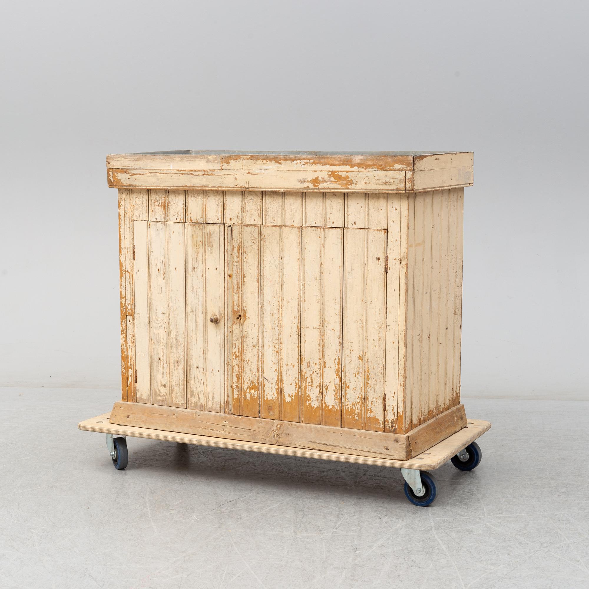 A late 19th Century cabinet with zink top.