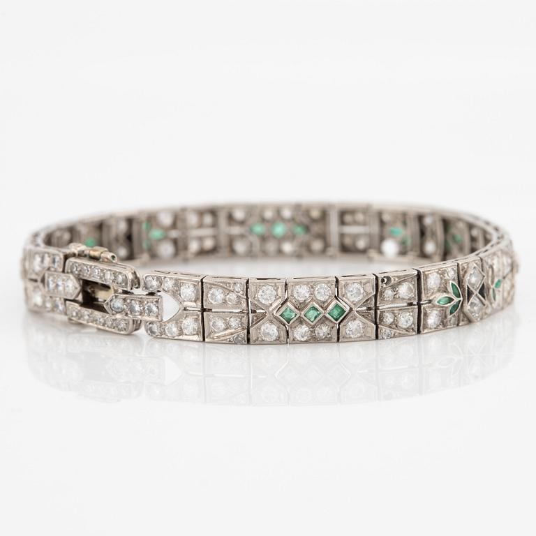 Bracelet in platinum set with round brilliant-cut, eight and step-cut diamonds, emeralds and onyx.