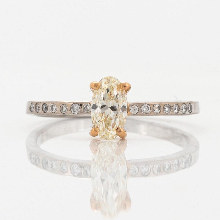 Oval diamond and brilliant-cut diamond ring.