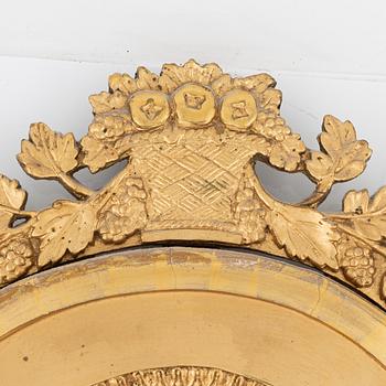 An Empire giltwood mirrored wall sconce by J. M. Berg (active in Gothenburg 1803- ca 1837).