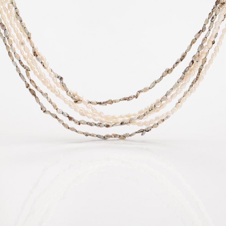 A six-strand pearlcollier with cultured pearls and a metal clasp.