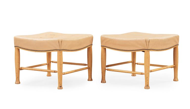 A pair of Josef Frank mahogany and beige leather stools, Svenskt Tenn, model 902.