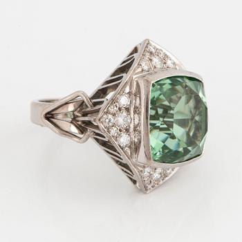 An 18K white gold ring set with a faceted tourmaline and round brilliant- and eight-cut diamonds.