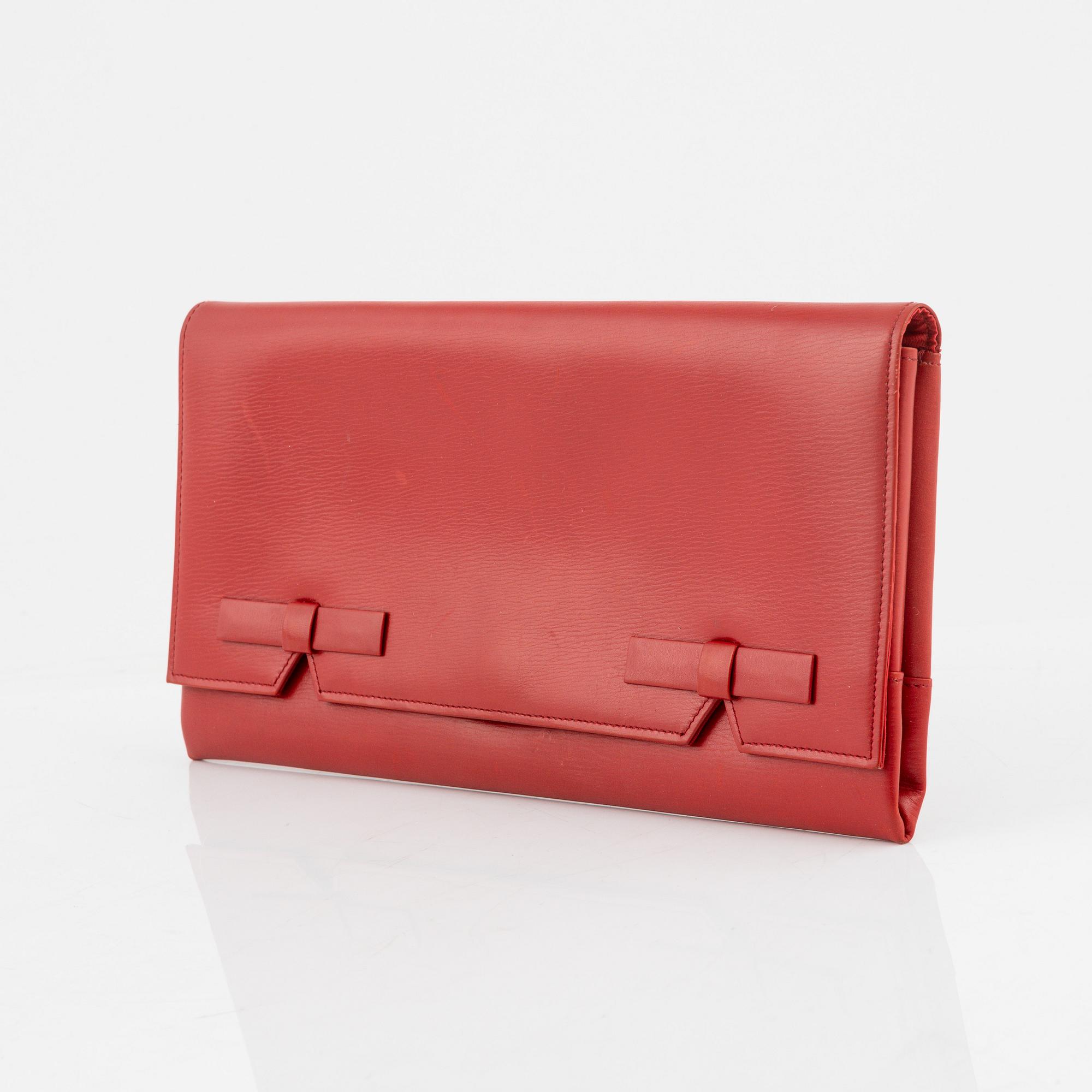 Christian Dior, a red box calf leather clutch.