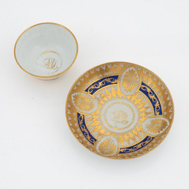 A blue and white porcelain tea cady, late Qing dynasty, 19th century, and a porcelain cup with saucer, Qing Dynasty, 19th century.