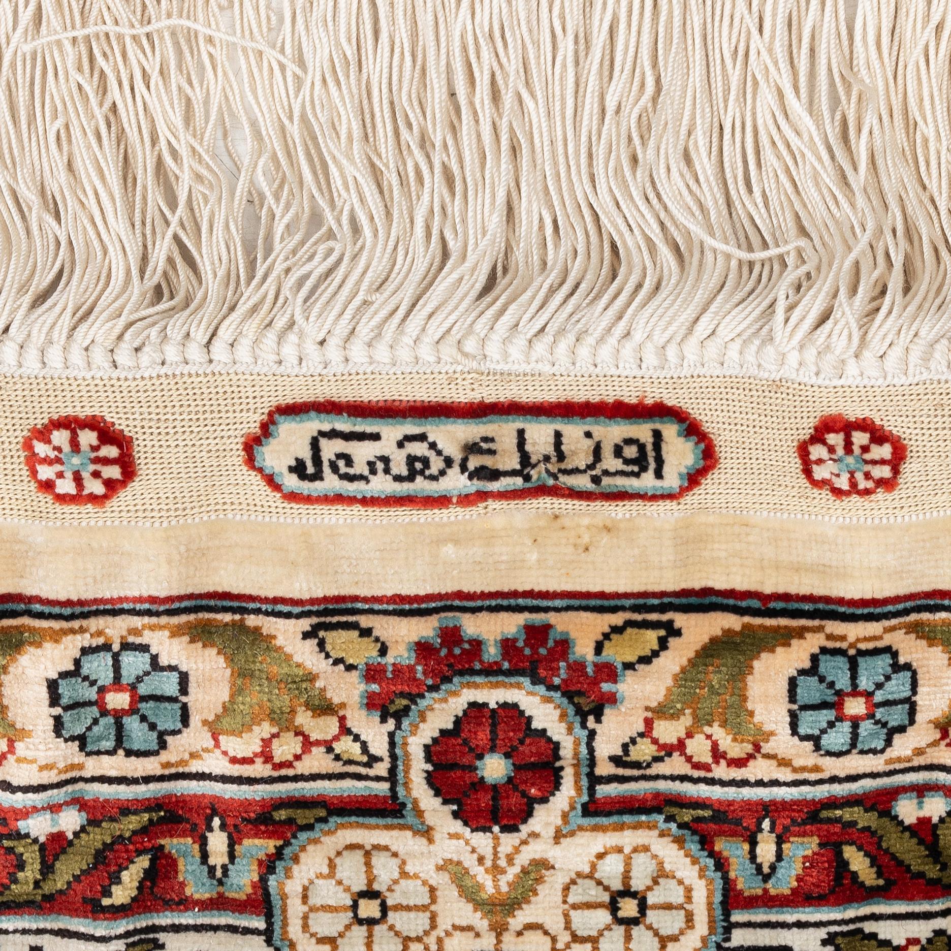 A semi-antique silk Hereke rug, West Anatolia, c. 180 x 121 cm.