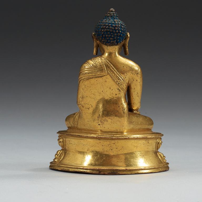 A gilt bronze figure of buddha, Presumably Tibet, 18th Century or older.