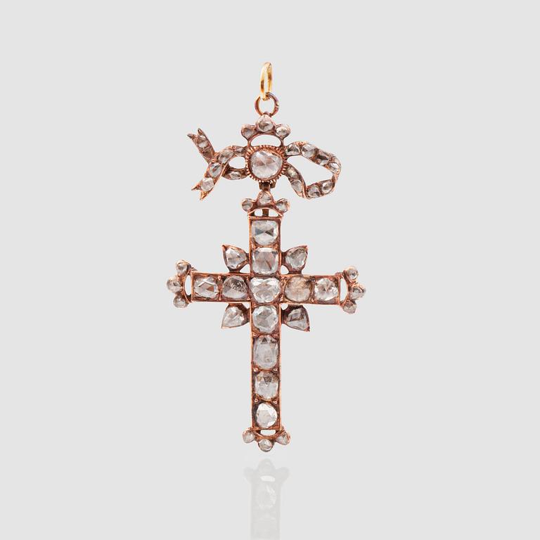 An antique-cut diamond pendant in the shape of a cross.