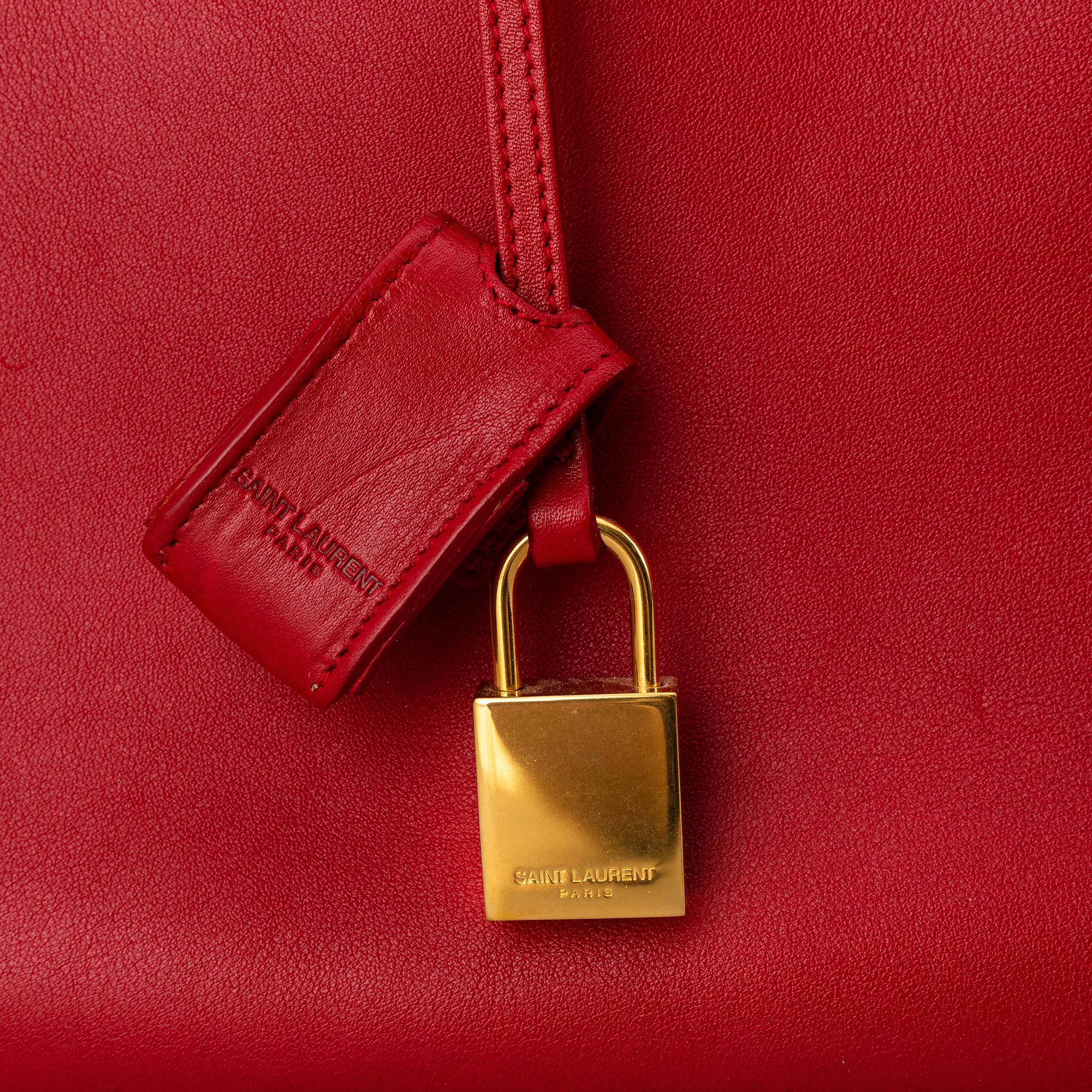 Saint Laurent, a red leather 'Sac du Jour Small' bag.