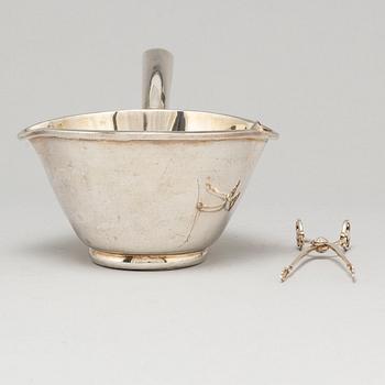 A Mexican sterling silver sauce pan and a Georg Jensen sugartangs, 20th century.