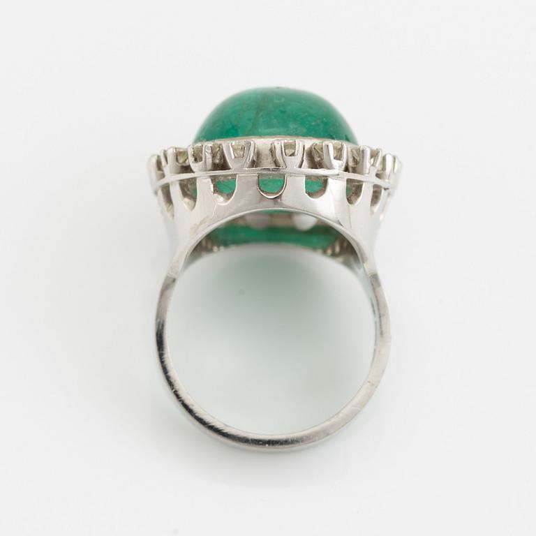 Cabochon cut emerald and brilliant cut diamond ring.