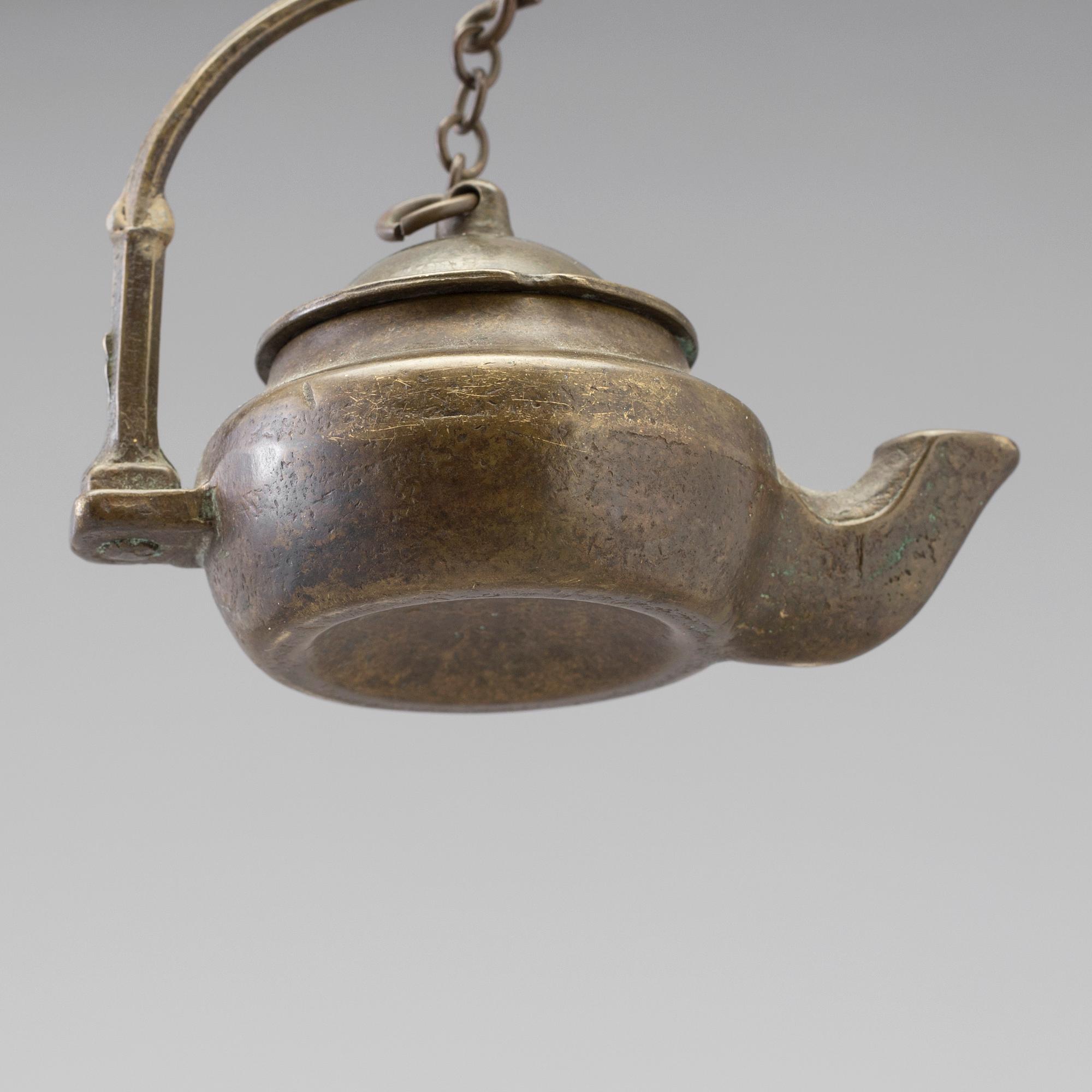 A 18th century oil lamp.