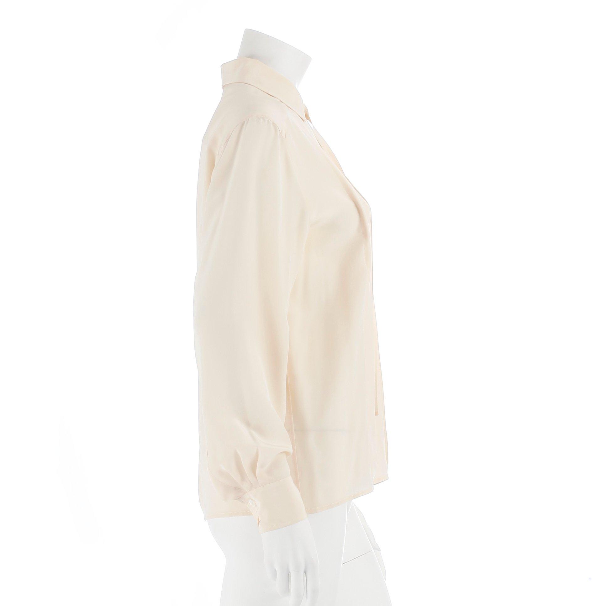 CÉLINE, a créme colored silk blouse.