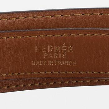 HERMÈS, a black leather belt.