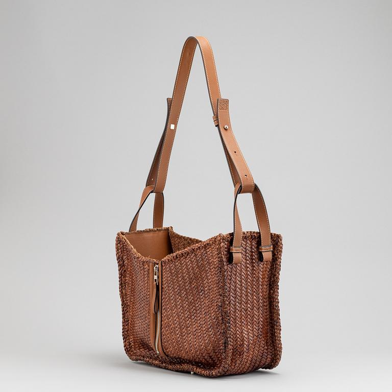 Loewe, a brown woven leather handbag.