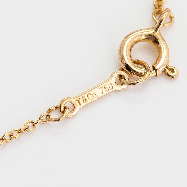 Tiffany & Co, Elsa Peretti, an 18K gold cross pendant necklace.