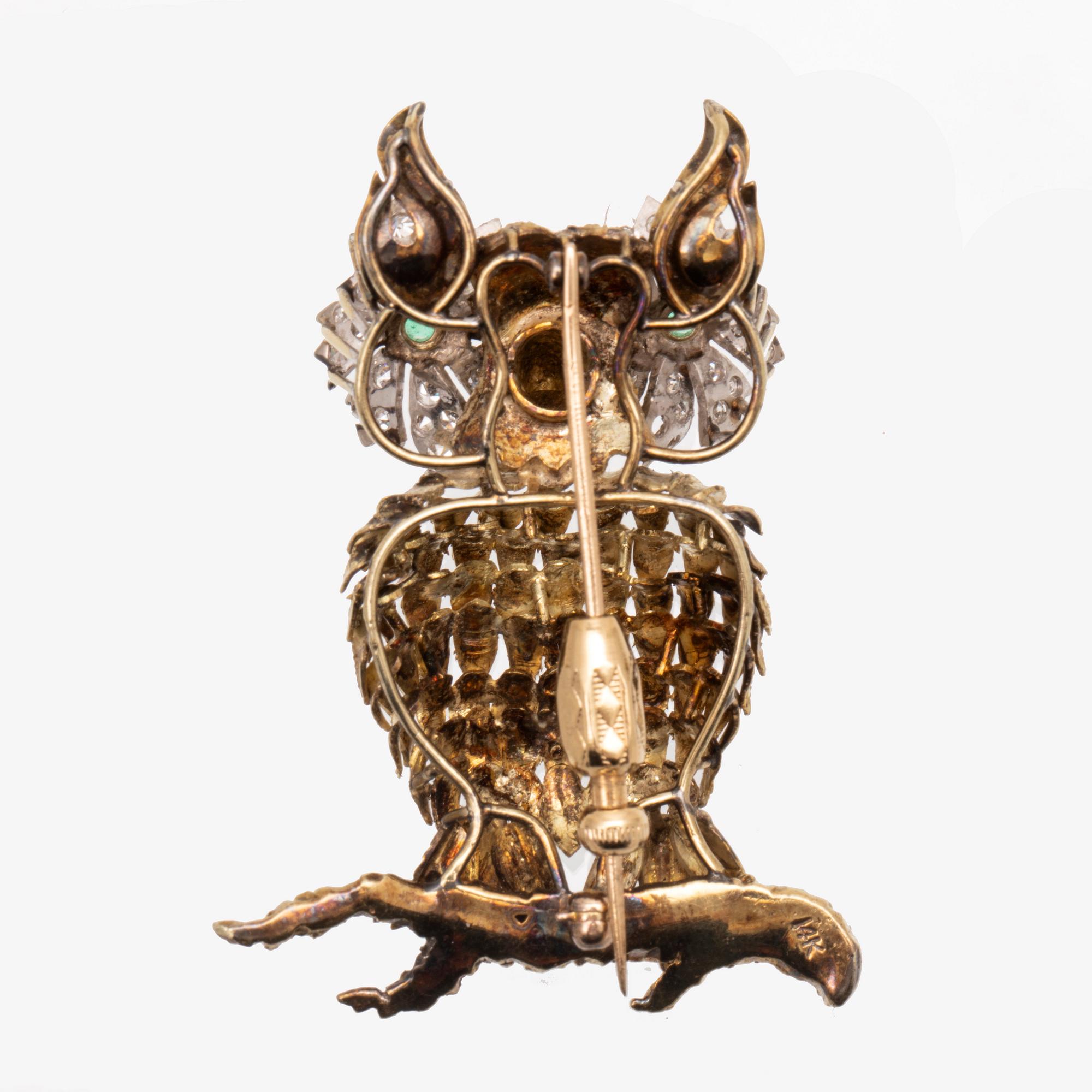 An 14K white and red gold brooch set with single cut diamonds and possibly emeralds.