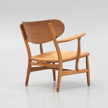 Hans J. Wegner, a model 'CH 22' armchair, Carl Hansen & Son, Odense, Denmark, mid 20th Century.