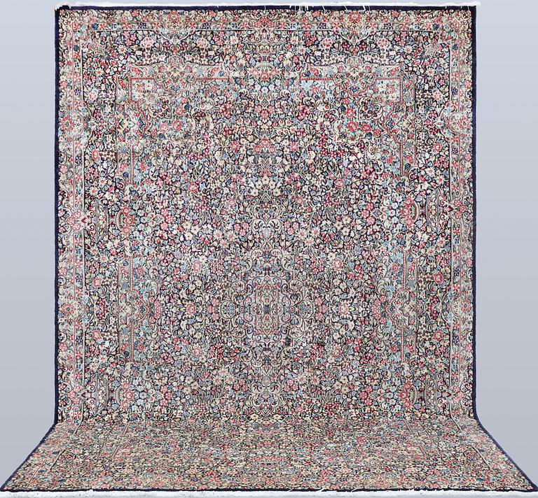 A Kirman Laver 'Millefleur' carpet, approx. 342 x 245 cm.