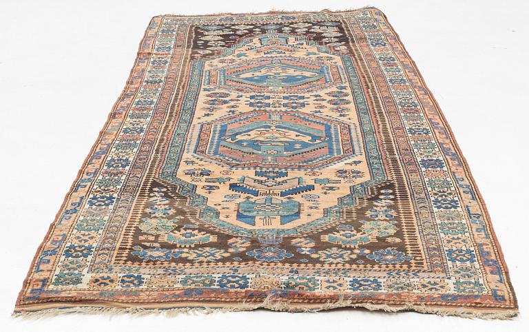 Rug, likely Kurdish, circa 1900, approximately 314 x 156 cm.