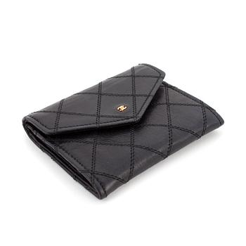602. CHANEL, a black quilted leather coin purse.