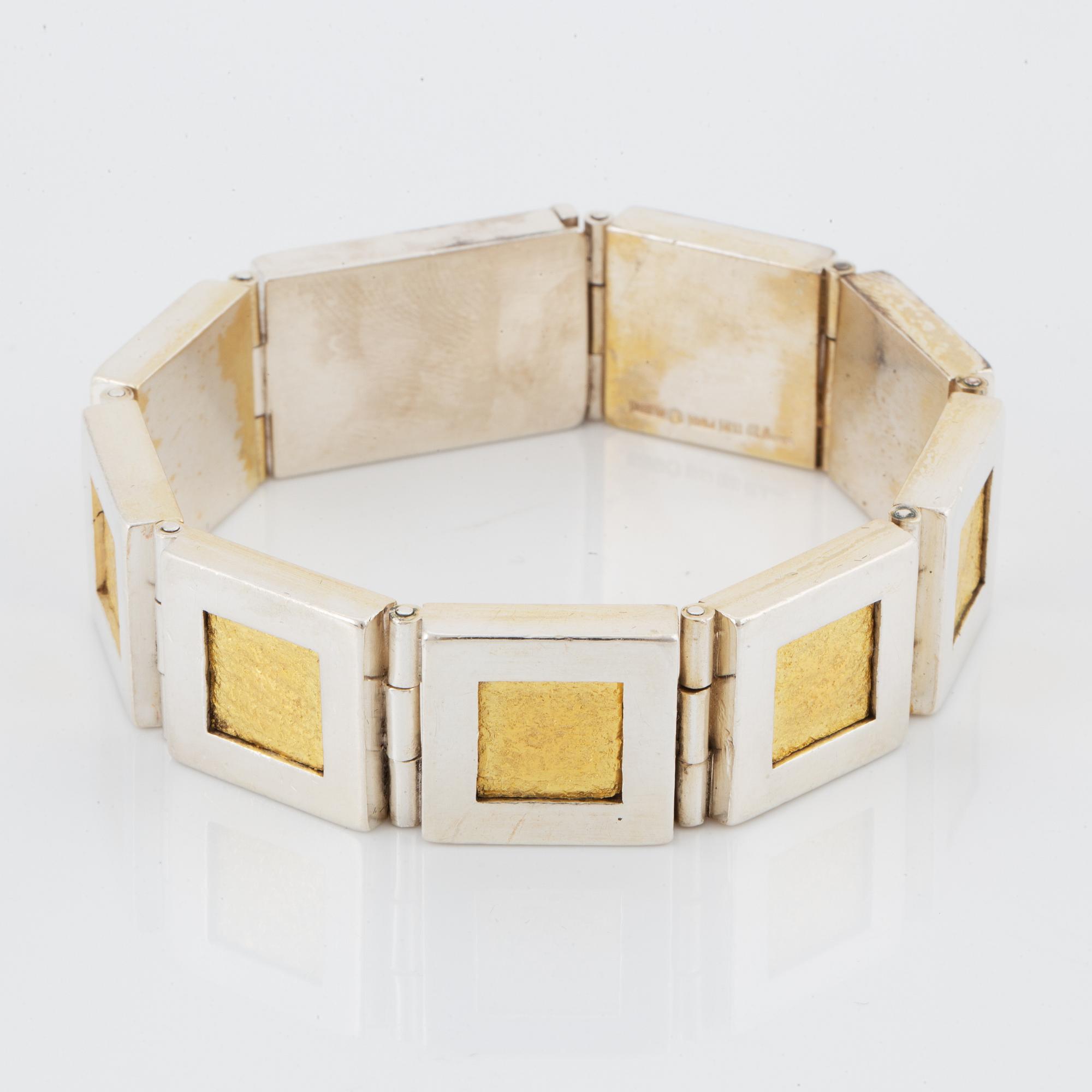 A Michael Hamma bracelet in silver and 18K gold.