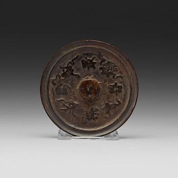 A bronze mirror, presumably Ming dynasty (1368-1643).