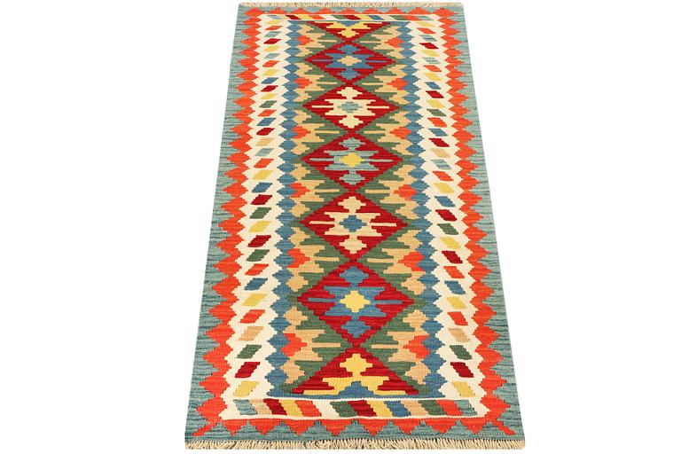 An Afghan kilim runner, c. 200 x 80 cm.