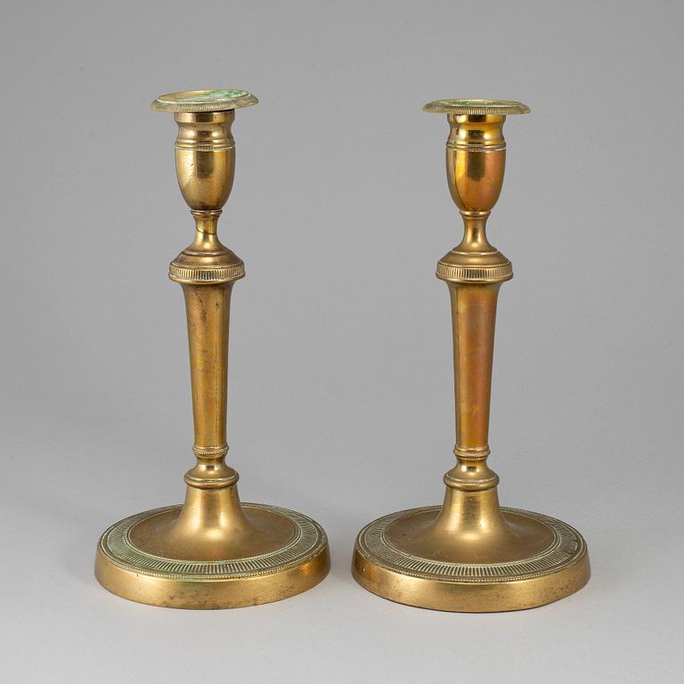 A pair of late 18th century bronze candlesticks.