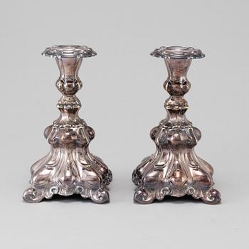 A pair of silver plate Rococo style candle sticks, 20th century.