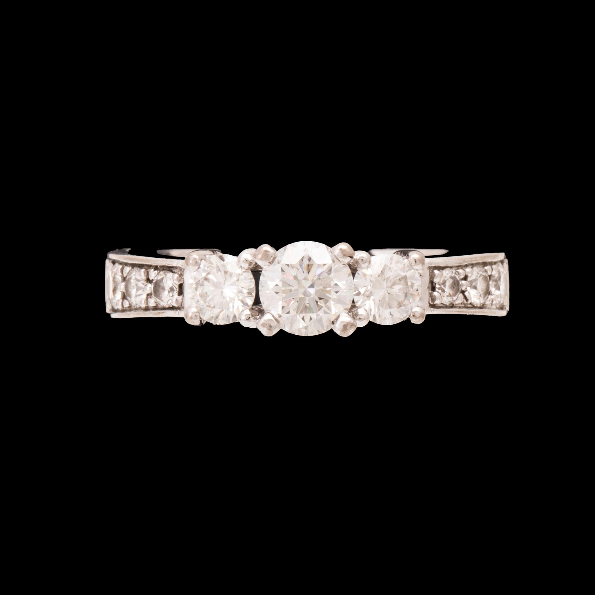 An 18K white gold ring set with round brilliant cut diamonds.