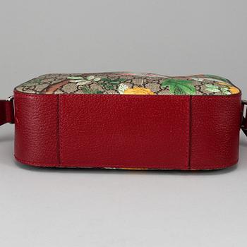 GUCCI, a patterned monogram canvas and leather bag.