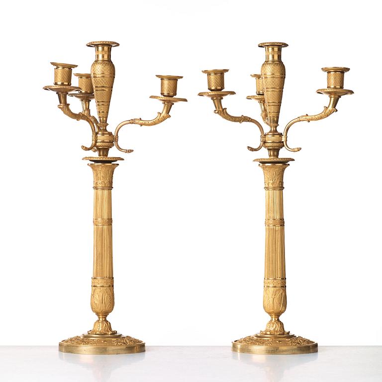 A pair of Empire early 19th century gilt bronze four-light candelabra.