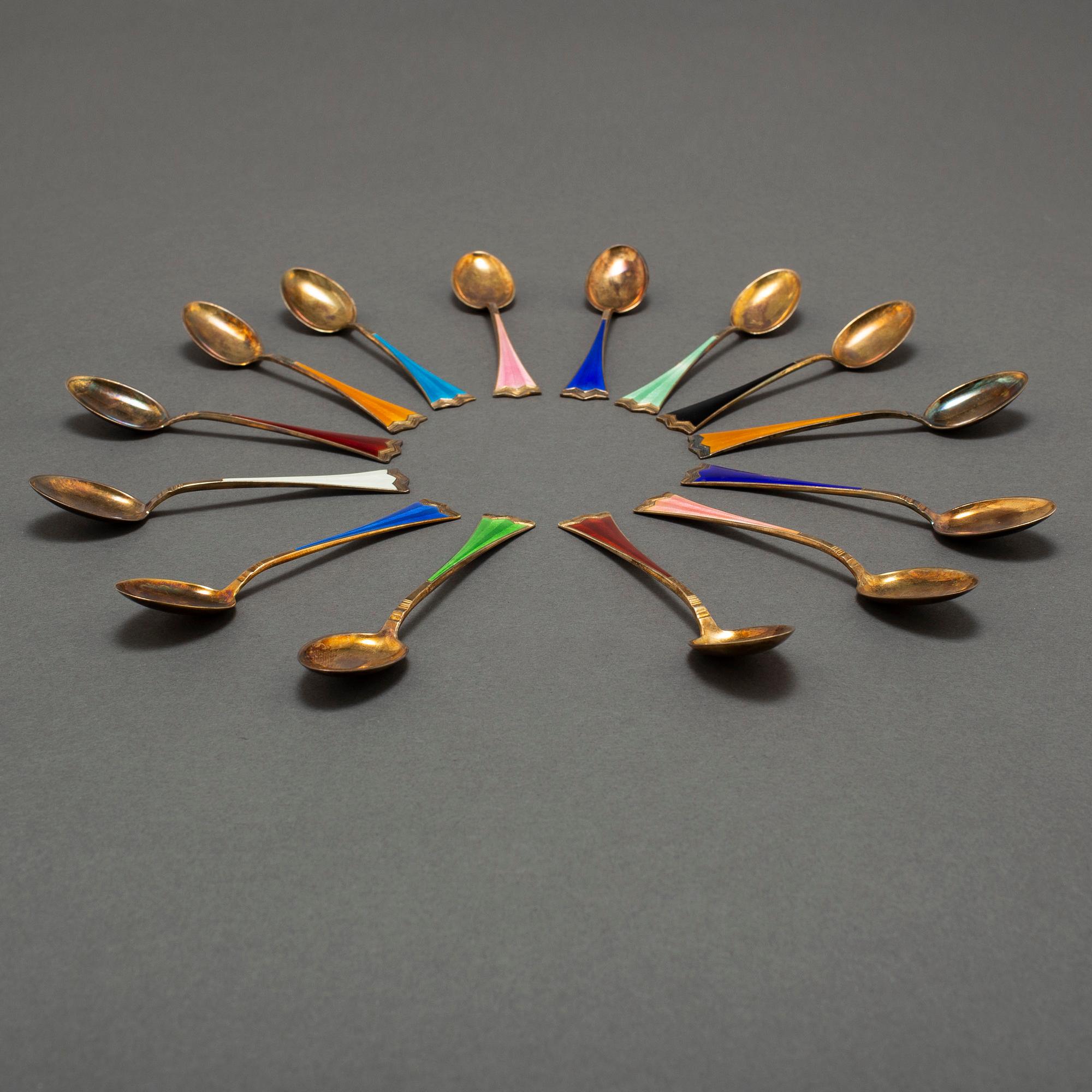 J TOSTRUP, 14 silver gilt and enamel coffee stoons from Oslo, Norway.