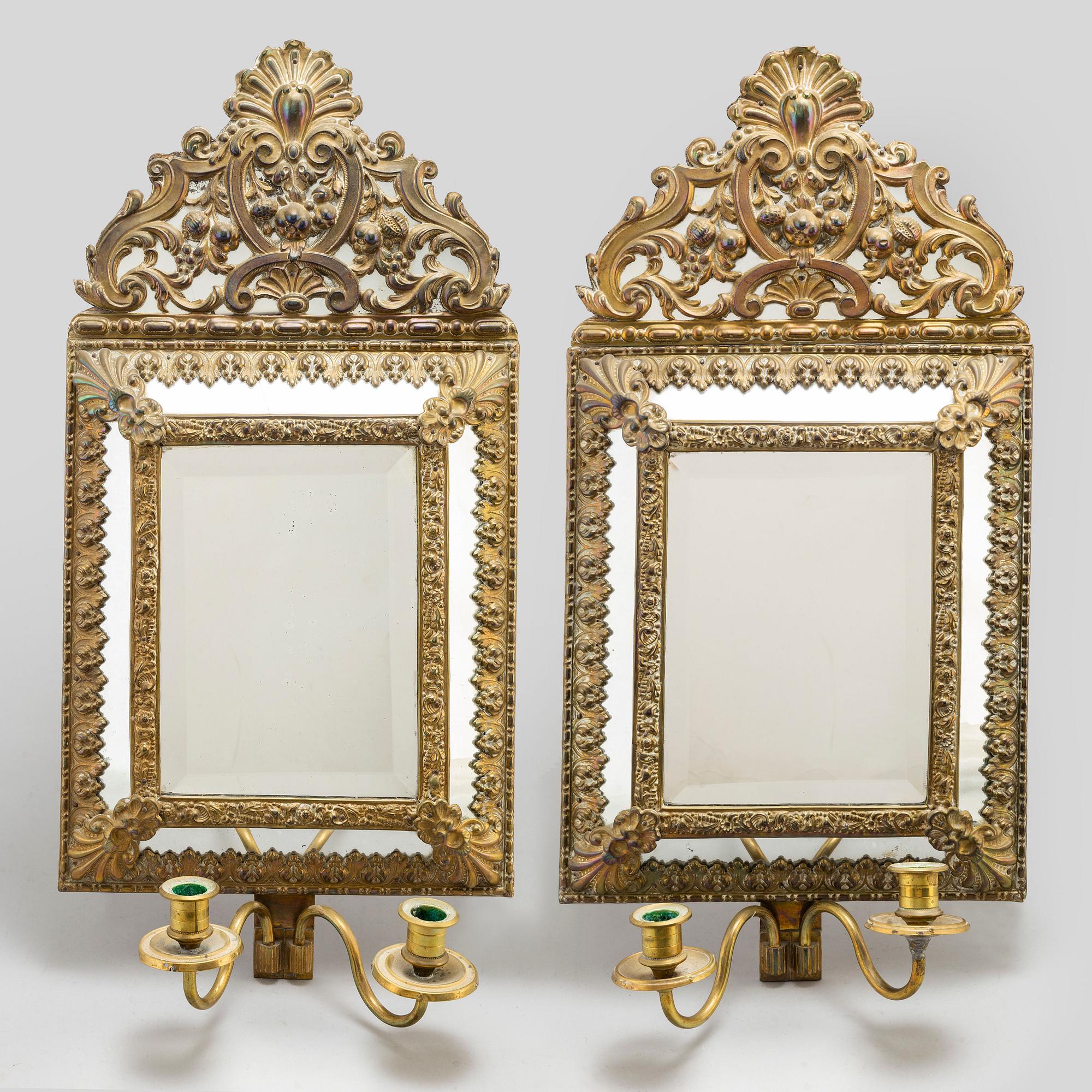 An early 20th Century pair of baroque style mirror sconses.