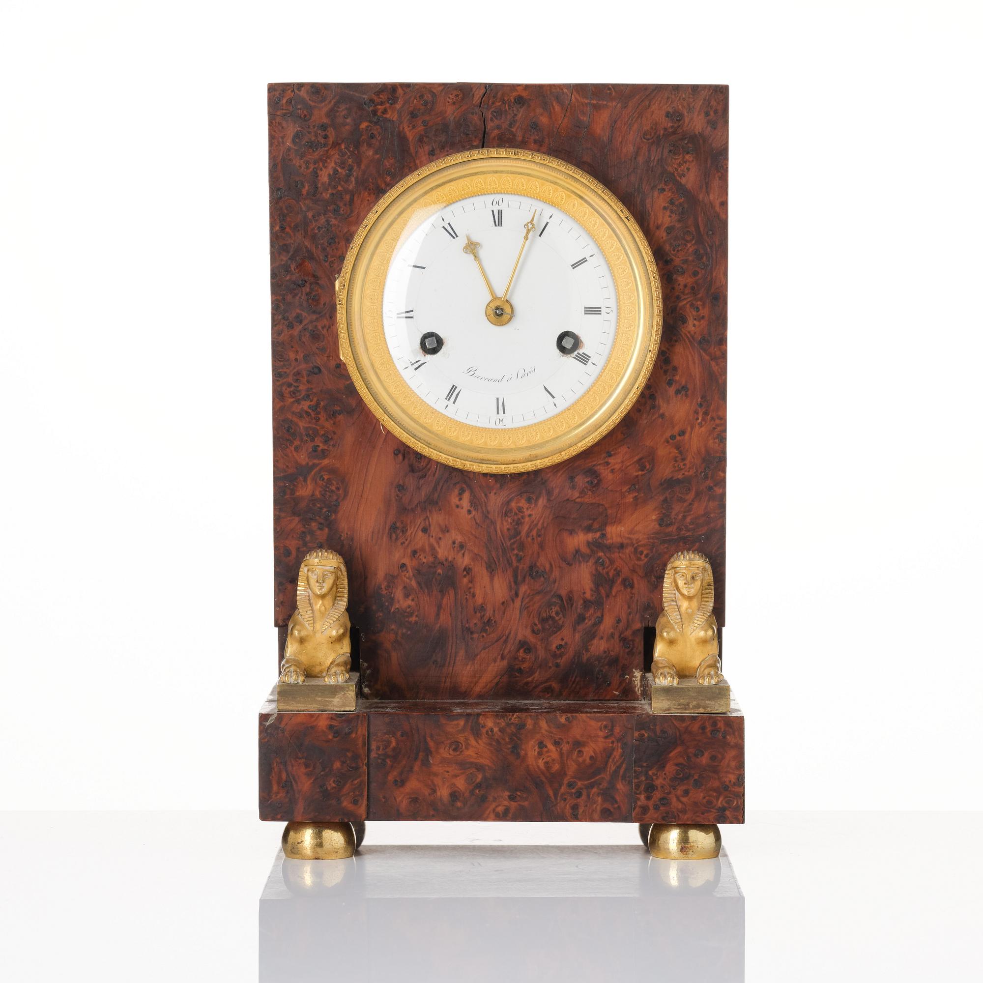 A French Empire burr-amboyna and ormolu mounted 'pendule borne' mantel clock by Barrand (master in Paris 1805-32).
