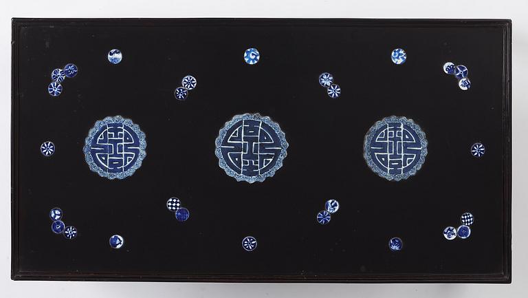 A Chinese black lacquered table with porcelain placques, presumably first half of the 20th century.