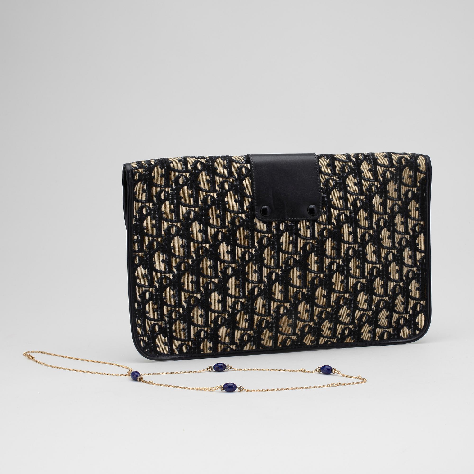 CHRISTIAN DIOR, a monogram canvas clutch bag and necklace.