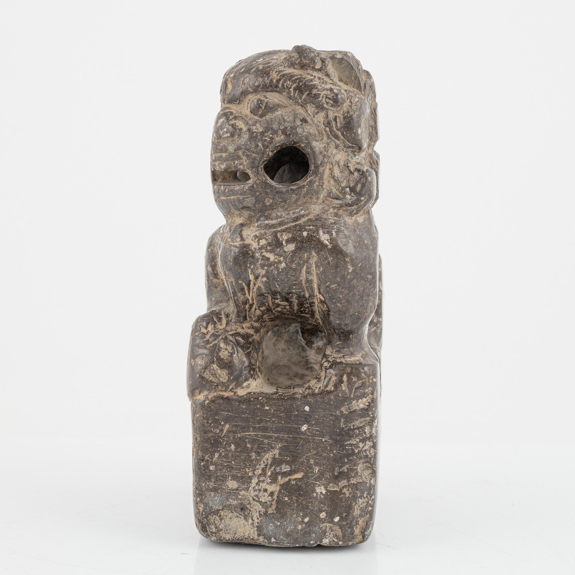 A stone scroll weight/sculpture of a buddhist lion, China, presumably Qing dynasty (1664-1912).