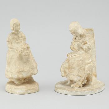 two plaster figurines, signed.
