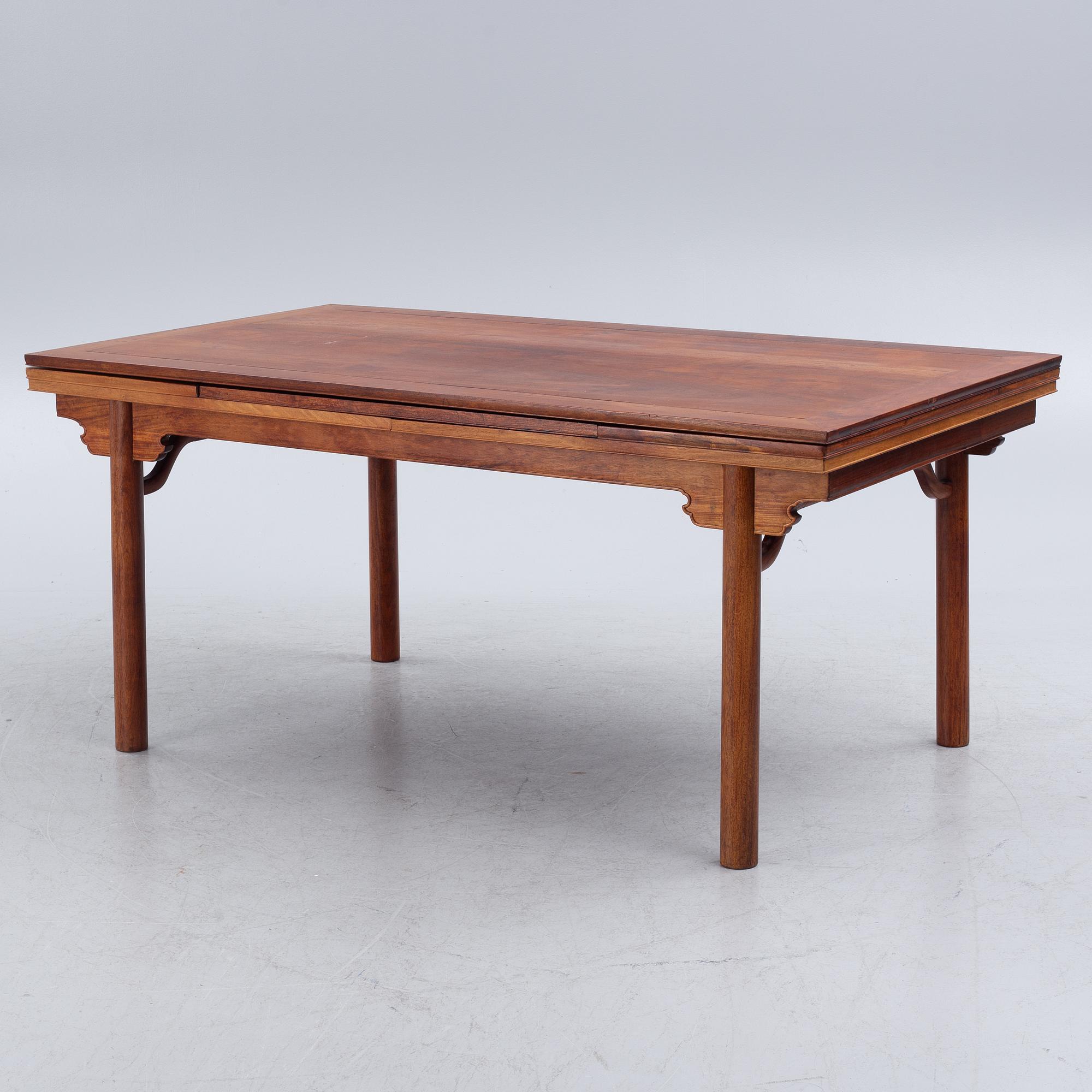 A Chinese hardwood dinner table and ten chairs with rattan seats, 20th century.