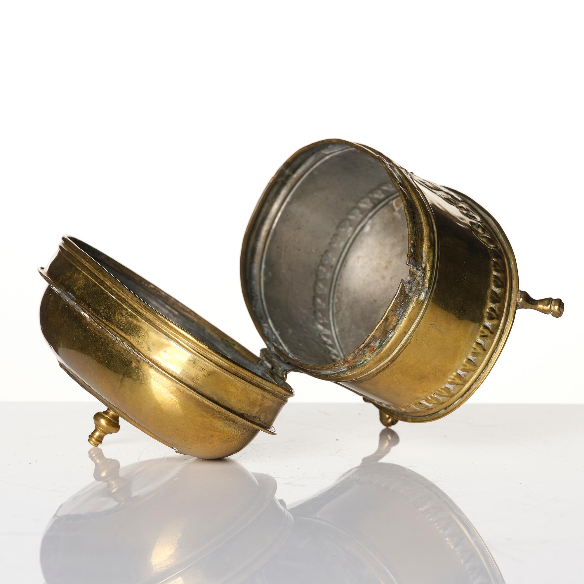 A baroque repousse brass pyxis, 18th century.