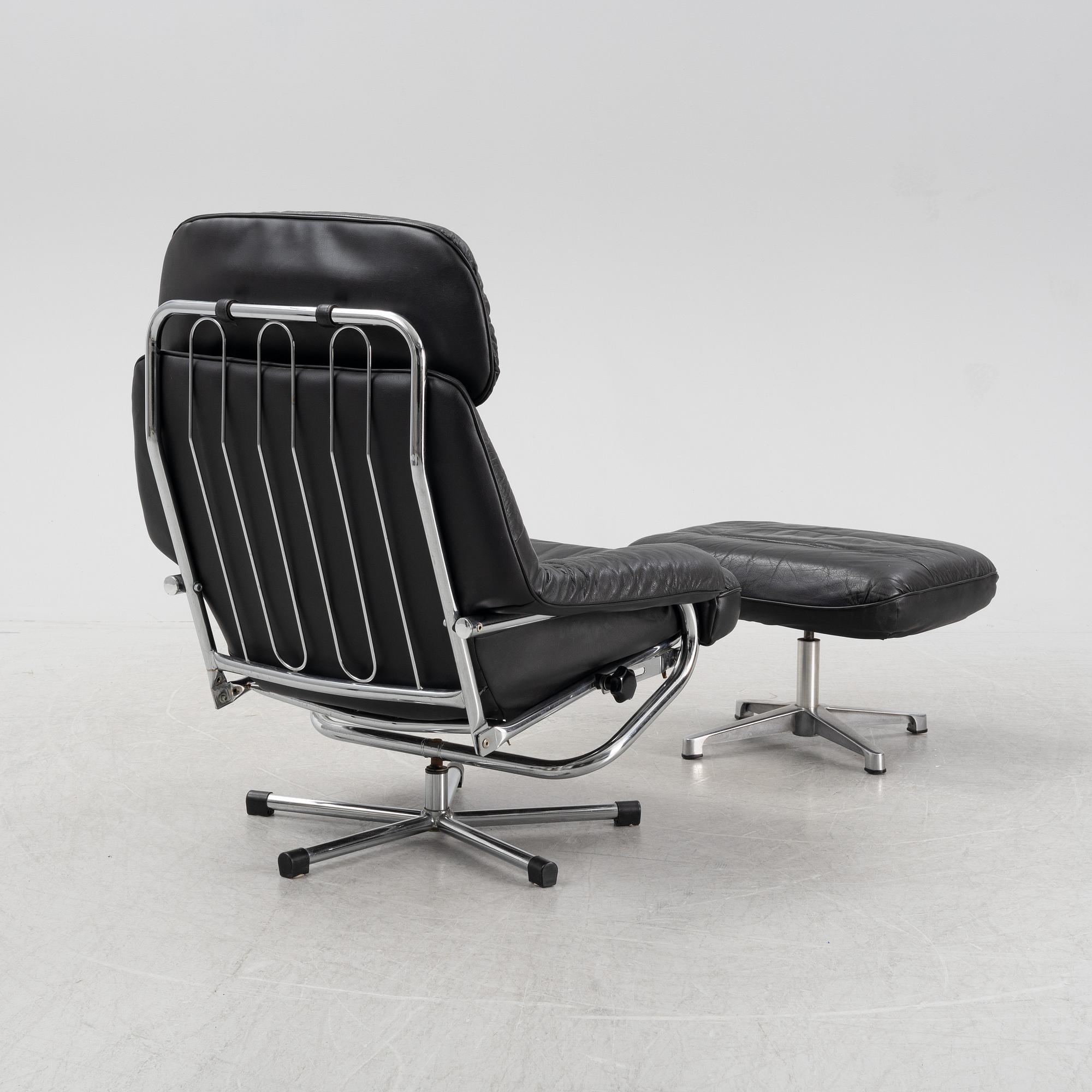 A leather and chrome lounge chair and foot stool, 1970's/80's.