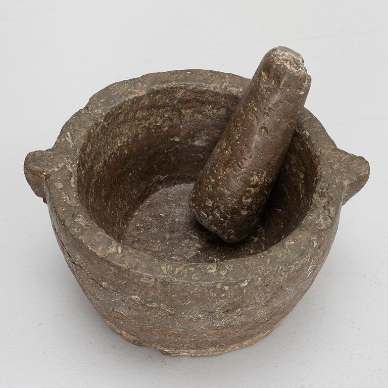 A llimestone mortar and pestle, 18th/19th Century.