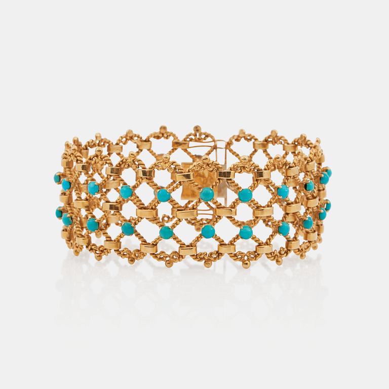 A gold and turquoise bracelet.