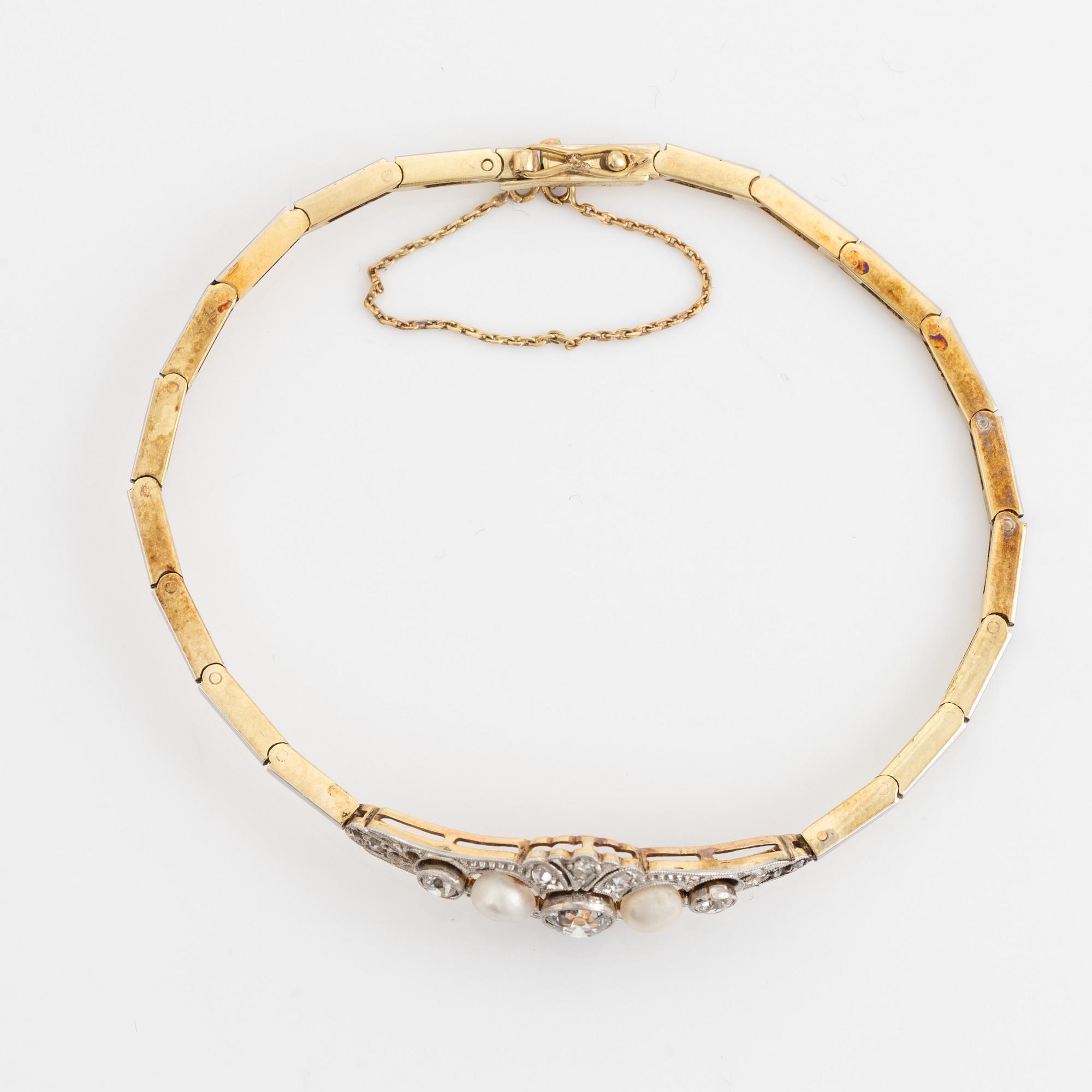 A 14K gold and platinum bracelet set with old- and rose-cut diamonds and pearls.