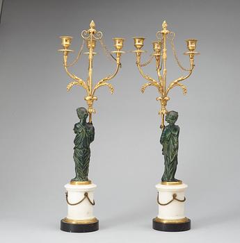 A pair of Louis XVI 18th century gilt and patinated bronze and marble three-light candelabra.