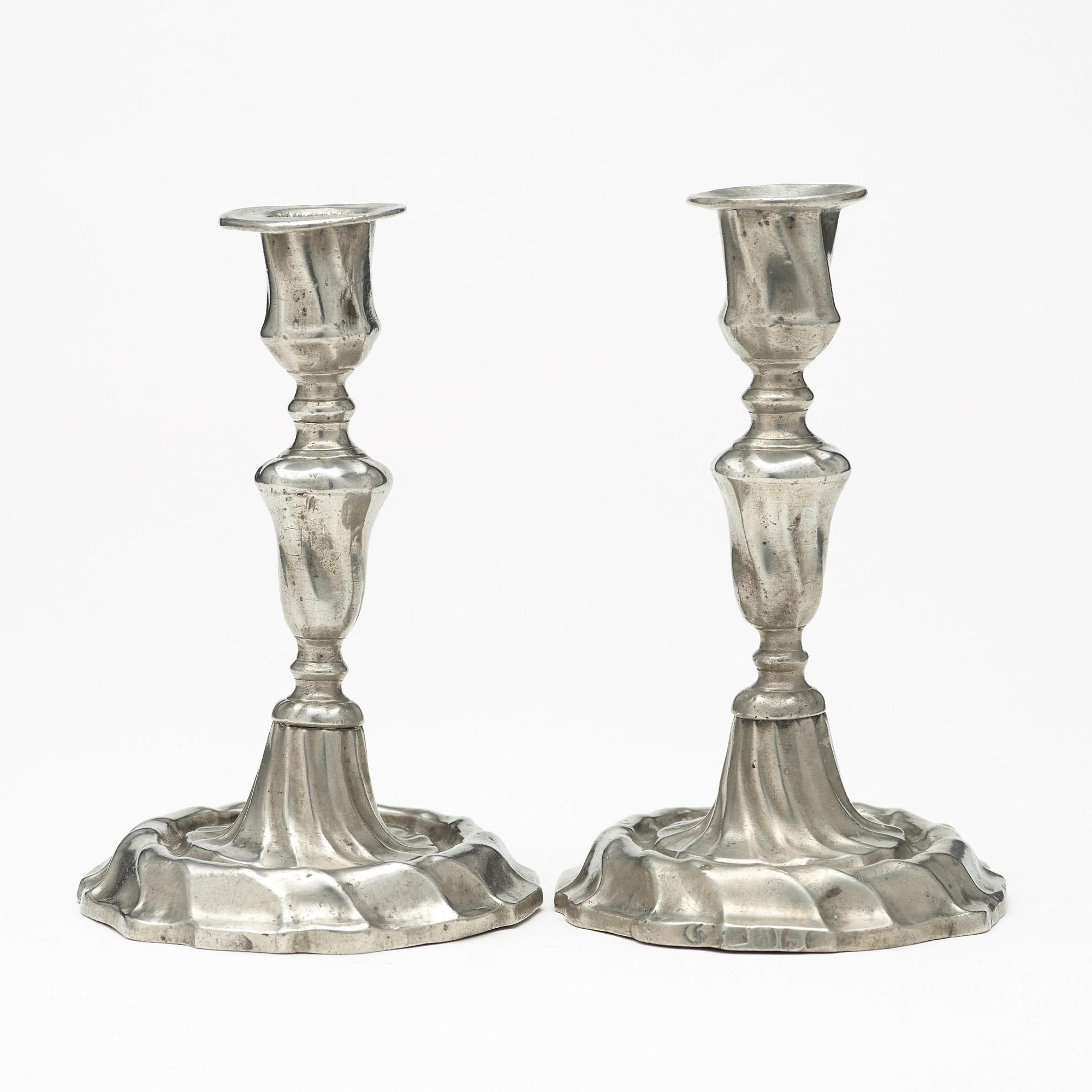 A pair of Swedish Rococo pewter candlesticks by L Lundwall 1762.