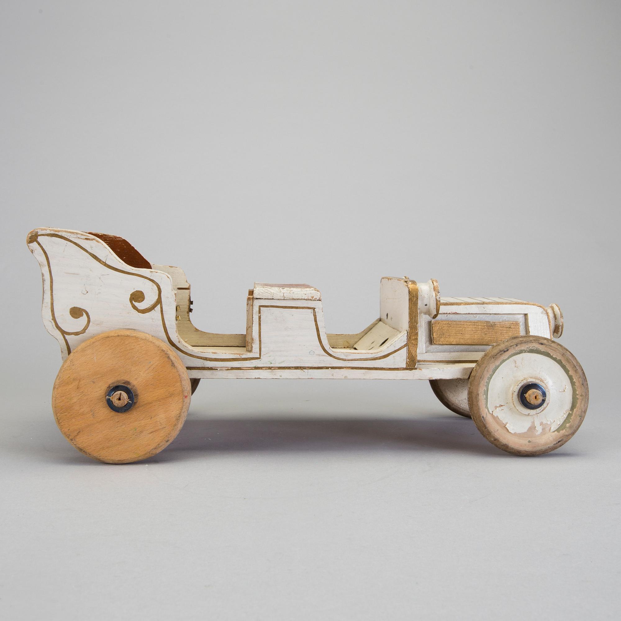 A painted wooden toy car c. 1910.