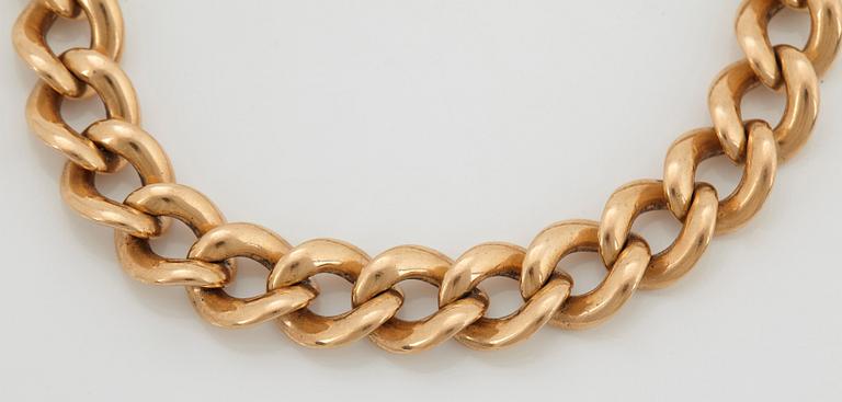 An 18K gold bracelet.